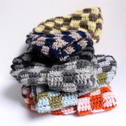 Multi-color checkered crochet wool beanie flat lay — handmade slow fashion MARVES New York